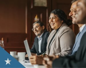 A group of insurance specialists sit in on a meeting.