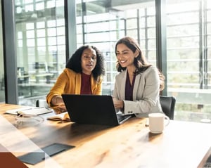 Two team members meet over a coffee break