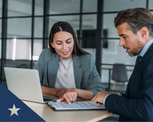 Two team members looking over a document